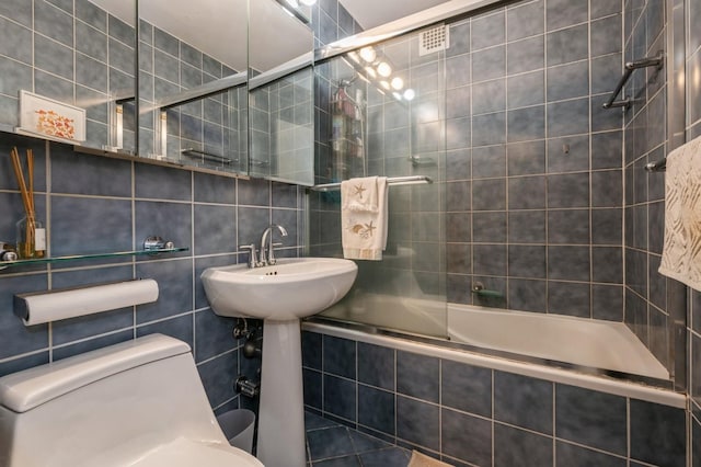 700 Shore Rd Unit 2Z, Long Beach, NY 11561 - bathroom with tile walls, toilet, tiled shower / bath combo, and backsplash