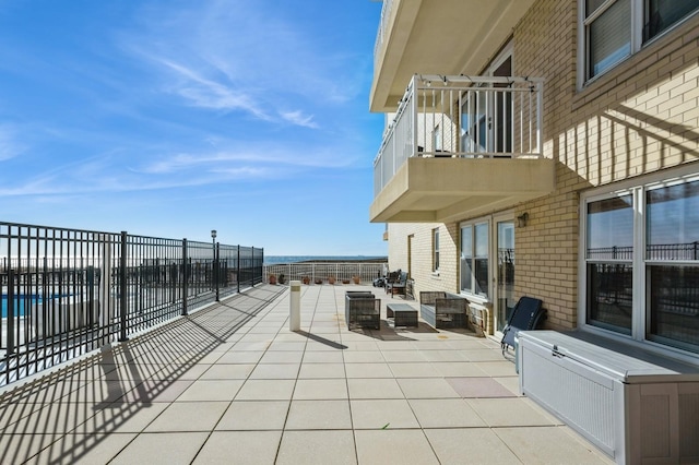 700 Shore Rd Unit 2Z, Long Beach, NY 11561 - view of patio featuring a balcony, an outdoor living space, and fence