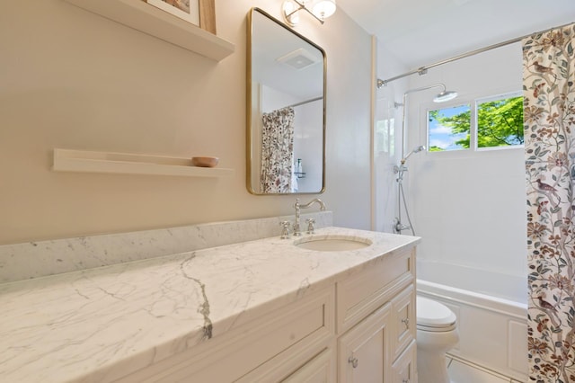 bathroom with toilet, vanity, and shower / tub combo