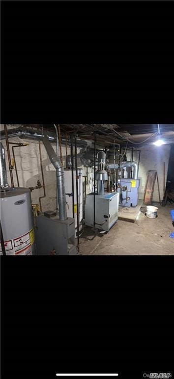 unfinished basement with a heating unit and gas water heater