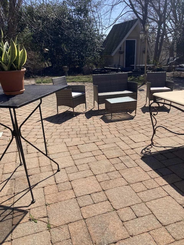 view of patio with an outdoor hangout area and an outdoor structure