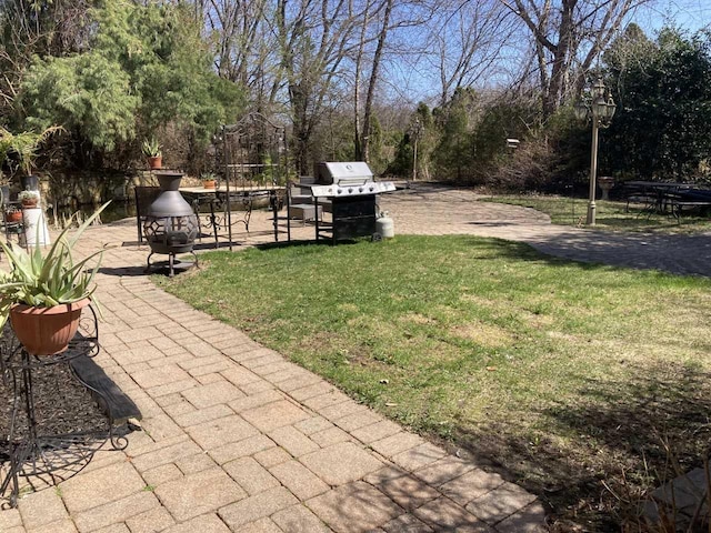 view of yard with a fire pit and a patio area