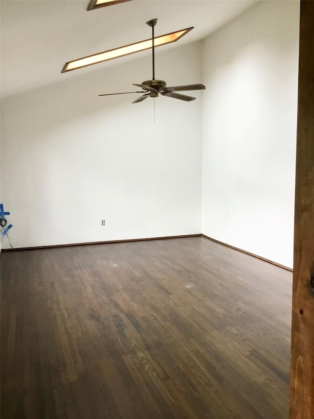 unfurnished room featuring wood finished floors, a ceiling fan, vaulted ceiling, and baseboards
