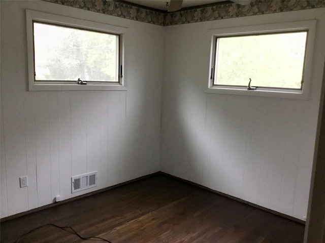 unfurnished room with dark wood finished floors