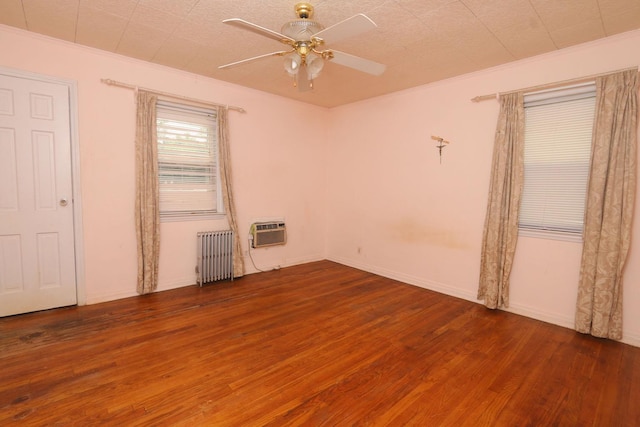 22 Primrose Dr, New Hyde Park, NY 11040 - spare room with radiator heating unit, wood finished floors, ceiling fan, ornamental molding, and a wall mounted air conditioner