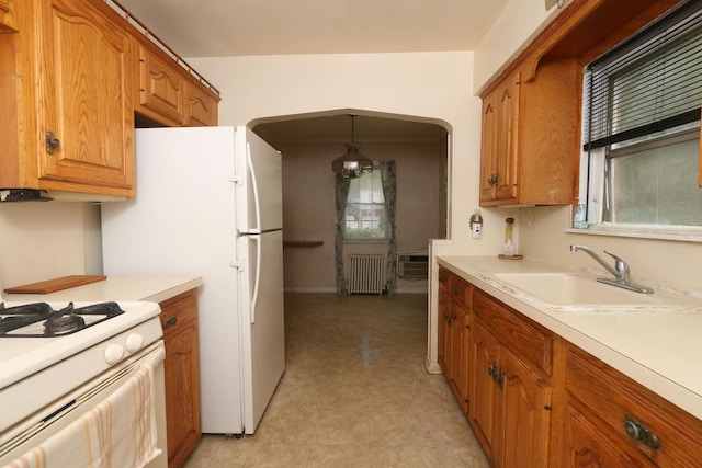 22 Primrose Dr, New Hyde Park, NY 11040 - kitchen with radiator heating unit, white range with gas stovetop, a sink, and healthy amount of natural light