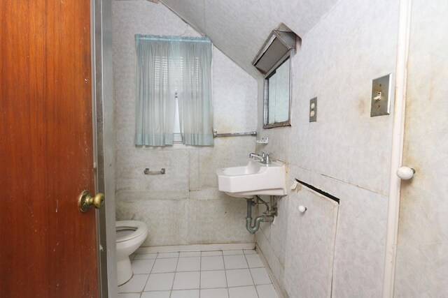 22 Primrose Dr, New Hyde Park, NY 11040 - bathroom featuring vaulted ceiling, toilet, tile patterned floors, and a sink
