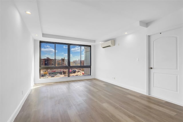 45-16 83rd St Unit E2J, Elmhurst, NY 11373 - unfurnished room with a wall unit AC, wood finished floors, baseboards, and recessed lighting