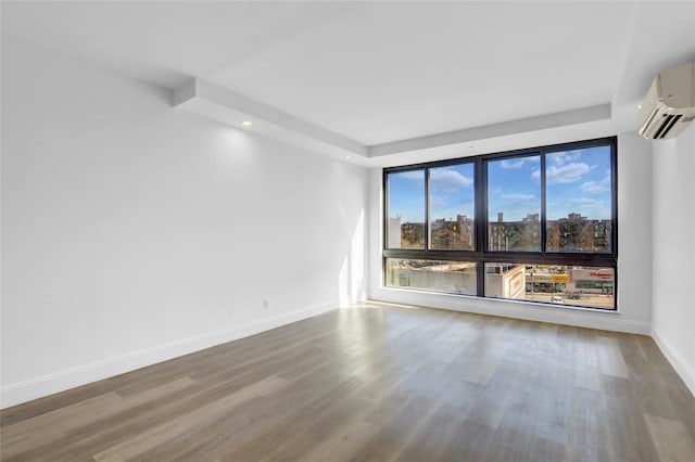 45-16 83rd St Unit E2J, Elmhurst, NY 11373 - empty room featuring a wall mounted AC, wood finished floors, baseboards, and recessed lighting