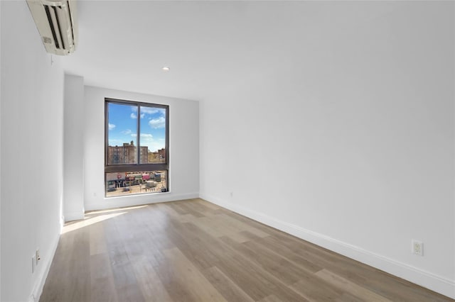 45-16 83rd St Unit E2J, Elmhurst, NY 11373 - empty room featuring an AC wall unit, baseboards, wood finished floors, and recessed lighting