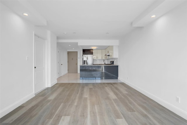 45-16 83rd St Unit E2J, Elmhurst, NY 11373 - unfurnished living room with light wood-style floors, baseboards, recessed lighting, and a sink