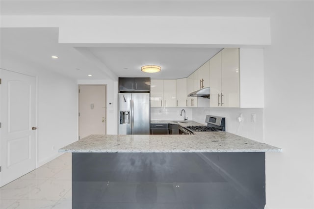 45-16 83rd St Unit E2J, Elmhurst, NY 11373 - kitchen with stainless steel appliances, a peninsula, light stone countertops, under cabinet range hood, and a sink