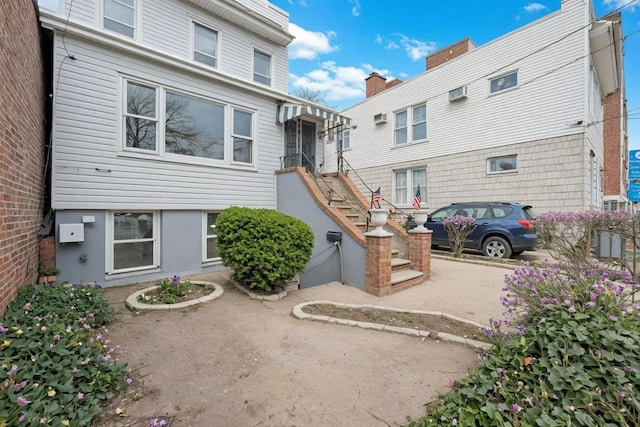6107 Grand Ave, Maspeth, NY 11378 - rear view of house featuring a wall mounted AC