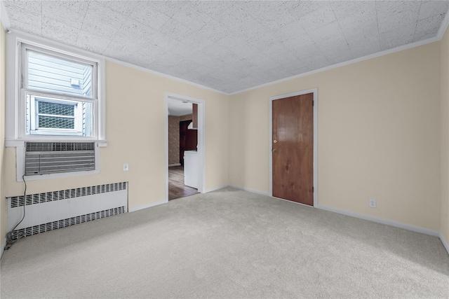 6107 Grand Ave, Maspeth, NY 11378 - carpeted spare room featuring radiator, crown molding, and baseboards