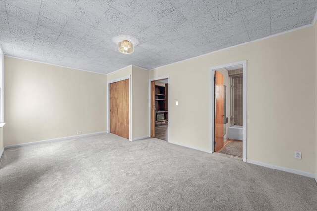 6107 Grand Ave, Maspeth, NY 11378 - unfurnished bedroom with carpet, ornamental molding, a closet, baseboards, and ensuite bath