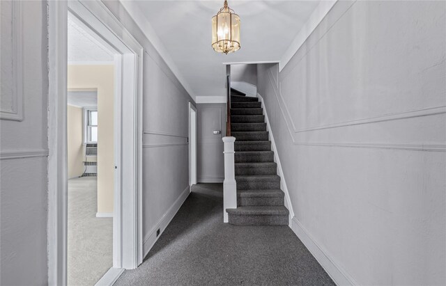 6107 Grand Ave, Maspeth, NY 11378 - stairs featuring carpet flooring, a chandelier, and baseboards