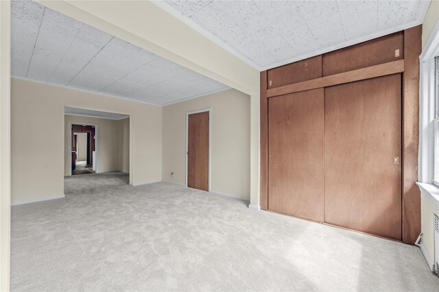 6107 Grand Ave, Maspeth, NY 11378 - unfurnished bedroom with carpet, baseboards, and a closet
