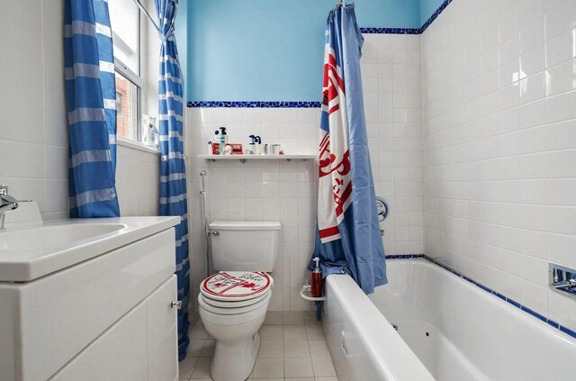 6107 Grand Ave, Maspeth, NY 11378 - full bathroom with tile walls, tile patterned flooring, toilet, shower / bath combo with shower curtain, and vanity