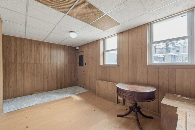 6107 Grand Ave, Maspeth, NY 11378 - basement featuring wood finished floors, a paneled ceiling, and wooden walls