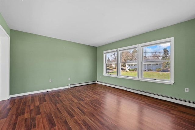 unfurnished room with a baseboard radiator, baseboards, a healthy amount of sunlight, and wood finished floors