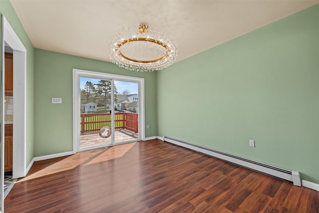 spare room with baseboards, baseboard heating, wood finished floors, and an inviting chandelier