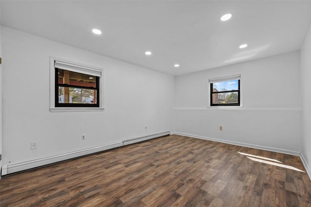 spare room with baseboards, wood finished floors, recessed lighting, and baseboard heating