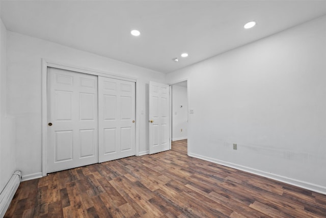 unfurnished bedroom with baseboards, a baseboard heating unit, recessed lighting, and dark wood-style flooring