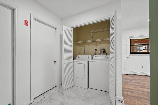 clothes washing area with marble finish floor, laundry area, and washer and dryer