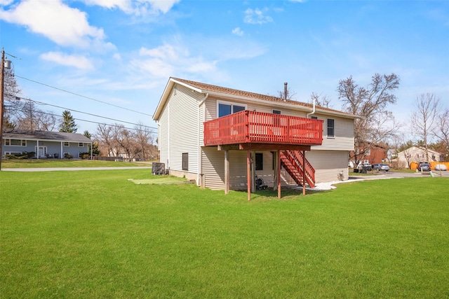 back of house featuring a wooden deck, driveway, stairway, and a lawn