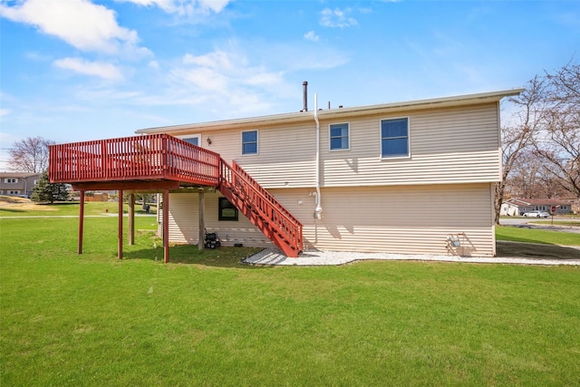 rear view of property featuring a wooden deck, stairway, and a yard