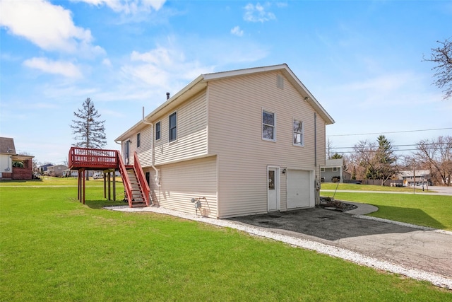 view of property exterior featuring a yard, stairway, aphalt driveway, and an attached garage