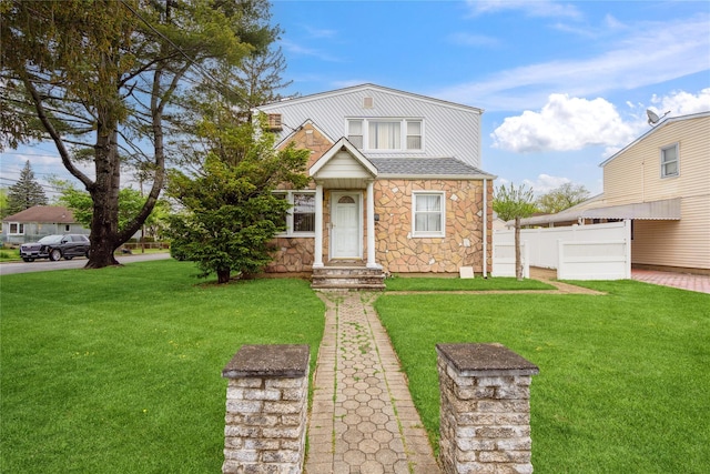 view of front of home featuring stone siding and roof with shingles
