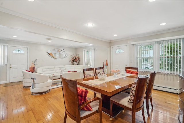 dining area with a baseboard heating unit, light wood-style floors, ornamental molding, and recessed lighting