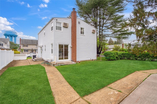 rear view of property with a chimney and a patio