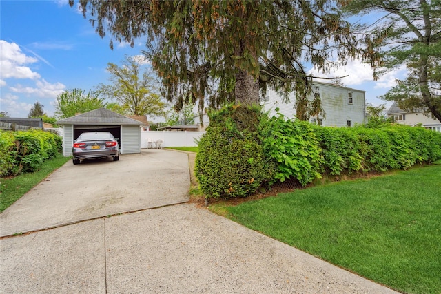 view of home's exterior with a detached garage and concrete driveway