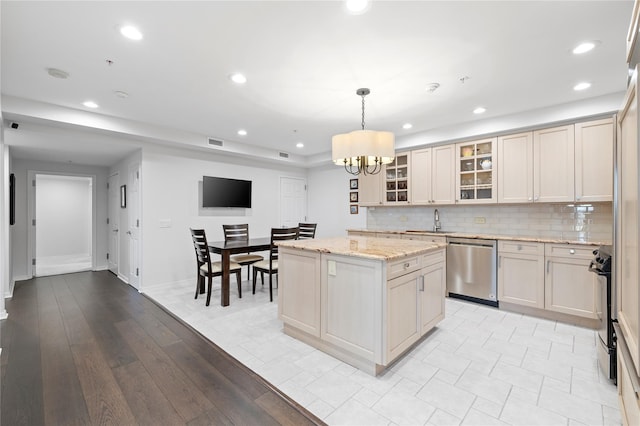 100 Harbor View Dr Unit 230, Port Washington, NY 11050 - kitchen featuring stainless steel dishwasher, a center island, a chandelier, backsplash, and glass insert cabinets