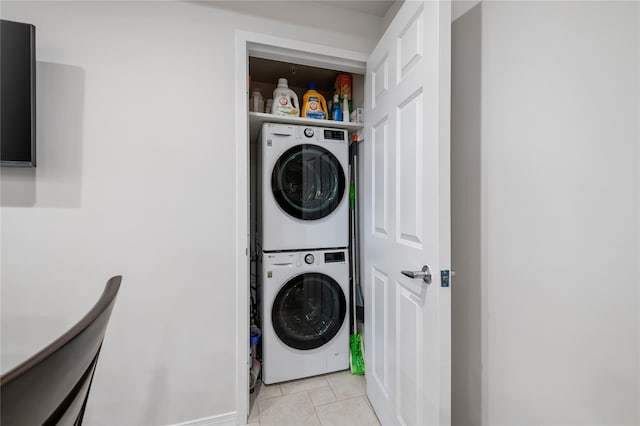 100 Harbor View Dr Unit 230, Port Washington, NY 11050 - washroom with estacked washer and dryer and light tile patterned flooring