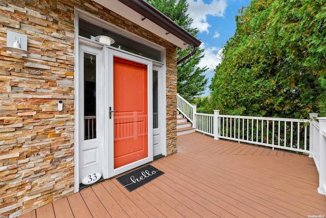 33 Old Canoe Place Rd, Hampton Bays, NY 11946 - doorway to property featuring stone siding and a wooden deck