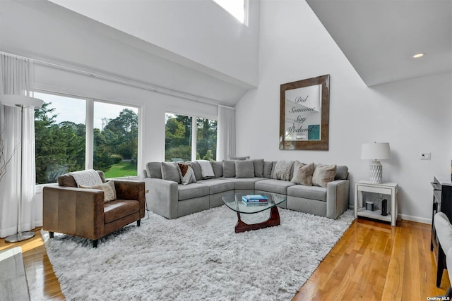 33 Old Canoe Place Rd, Hampton Bays, NY 11946 - living room featuring a high ceiling, baseboards, light wood-style floors, and recessed lighting