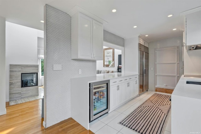 33 Old Canoe Place Rd, Hampton Bays, NY 11946 - kitchen featuring light countertops, wine cooler, stainless steel built in refrigerator, white cabinetry, and recessed lighting