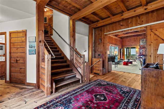 1635 Isabella Beach Rd, Fishers Island, NY 06390 - entrance foyer with wood walls, hardwood / wood-style flooring, wood ceiling with exposed beams, and stairway