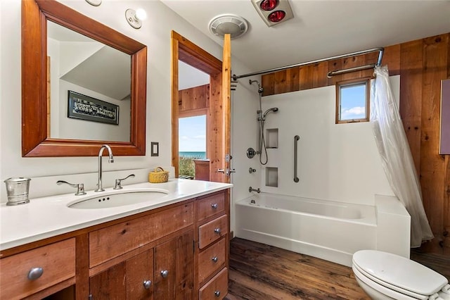 1635 Isabella Beach Rd, Fishers Island, NY 06390 - bathroom featuring shower / bath combo with shower curtain, vanity, wood finished floors, and toilet