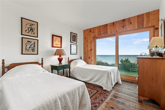1635 Isabella Beach Rd, Fishers Island, NY 06390 - bedroom featuring access to exterior, wood-type flooring, a water view, and wood walls