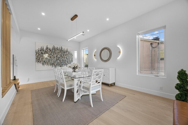 dining space featuring baseboards, recessed lighting, and light wood-style floors