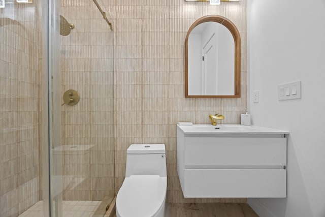 full bath with toilet, a stall shower, and vanity