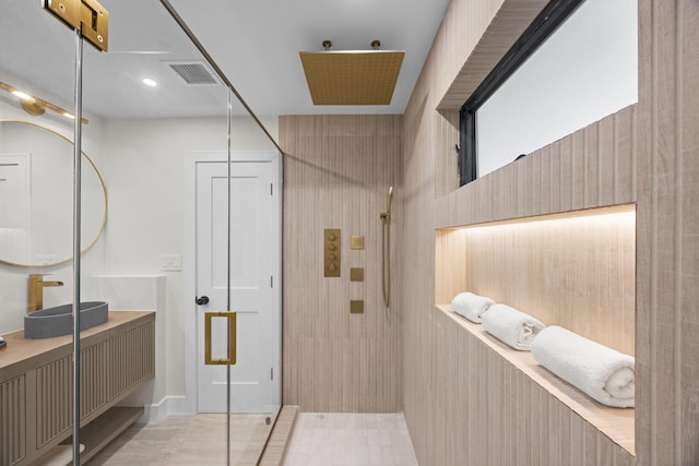 full bath with visible vents, tiled shower, and vanity