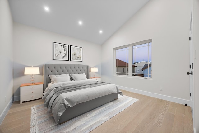 bedroom with baseboards, high vaulted ceiling, recessed lighting, and light wood-style floors