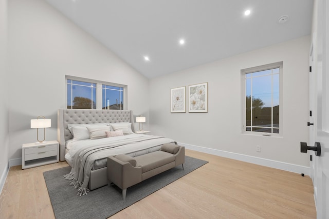 bedroom with baseboards, wood finished floors, and recessed lighting