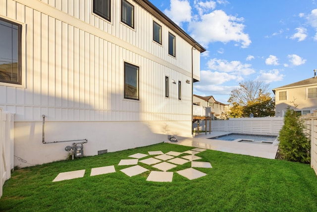 view of yard with a fenced backyard, a hot tub, and a patio area