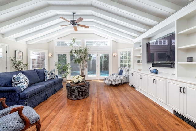 living room with light wood-style floors, visible vents, vaulted ceiling with beams, and ceiling fan